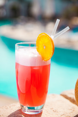 Obraz premium summer cocktail by pool. Delicious beverages