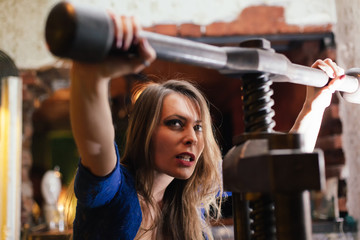 young woman tightening huge vice