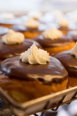 Delicious bakery display of cream filled chocolate frosted donuts