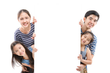 Smiling happy Asian family with big white poster on isolated background