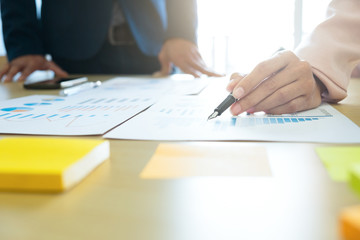 Business concept discussing graphs showing the results of their