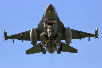 Flying military fighter jet front view