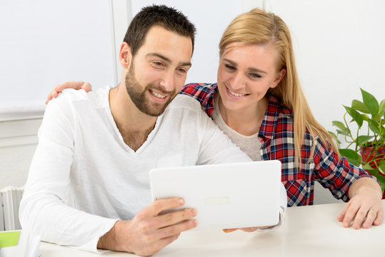 happy young couple using digital tablet