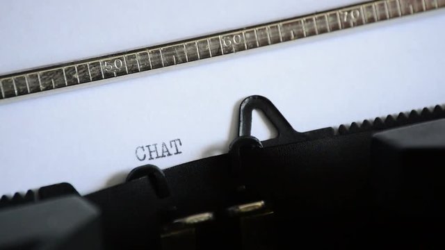Typing the word CHAT with an old manual typewriter