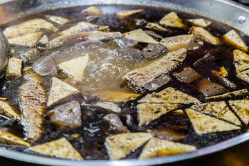 Tofu boiling in steel pot