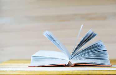 Open book on wooden table. Back to school. Copy space