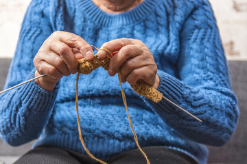 elderly woman knits 