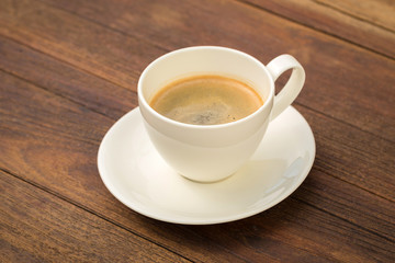 Coffee cup on wooden background