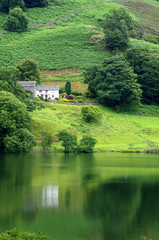 Fototapeta na wymiar Lake District view (reflection of a house in a lake)