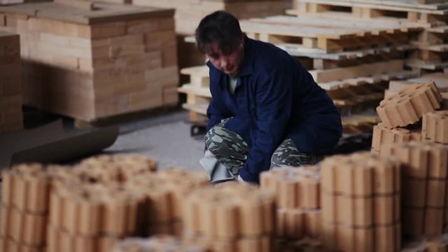Work on the factory floor packs products. factory workers adds refractory bricks for further packaging.