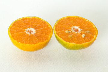 Two half orange fruit on white background, fresh and juicy