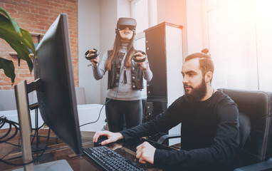 The young man with girlfriend plays a game at the office.