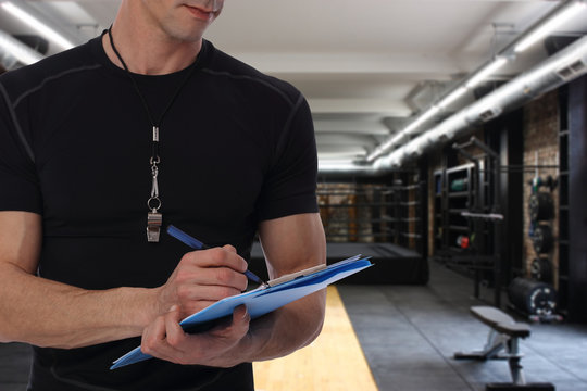 Boxing trainer, coatch with workout plan close up in gym background. Sport, fitness and healthy life style concept.