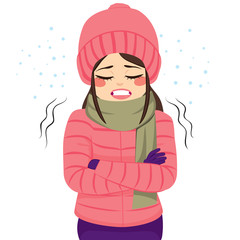 Young woman freezing wearing winter clothes shivering