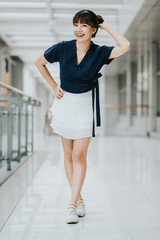 Portrait of young happy Asian girl smiling indoor