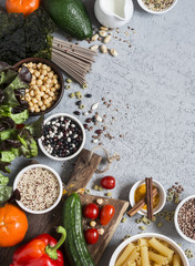 Vegetarian food background. Set of vegetarian products on the gray table, top view. Healthy, diet food concept. Free space