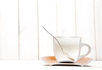 half cup with tea and spoon