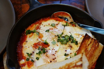 Shakshouka dish of eggs poached in tomato sauce