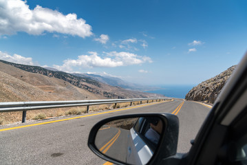 View on road of Crete island from driving car