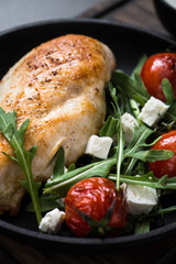 Grilled chiken fillet and fresh vegetables salad.