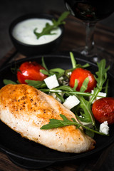 Grilled chiken fillet and fresh vegetables salad.