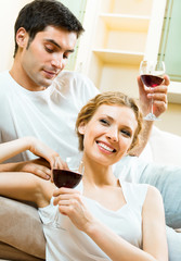 couple celebrating with redwine at home
