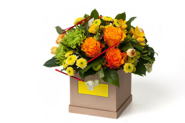 orange roses and an assortment of colors in cardboard box. Valentine's Day