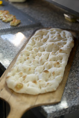 freshly italian baked pizza dough on wooden shovel