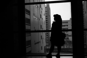 Fototapeta na wymiar black and white business women Silhouette looking to the window future