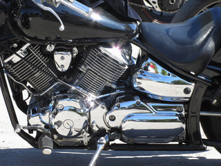 Motorcycle chromed engine closeup detail. Side view