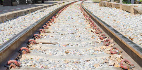 Old railroad tracks at a train station close up background