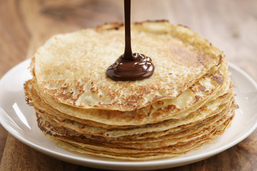premium dark chocolate pour on freshly made blinis or crepes, simple sweet food