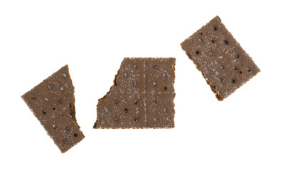 Chocolate graham cracker broken in three pieces isolated on a white background.