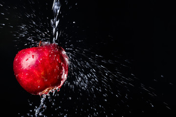 apple in water on black background