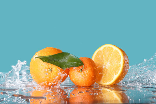 fresh orange with water splash on green background