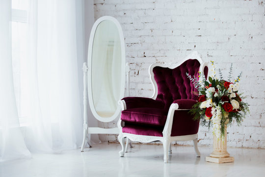 Vintage style chair in classical interior room with big window and flowers