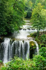 Tuinposter Watervallen Beautiful forest cascade waterfall with clear, spring river wate  © domagoj8888