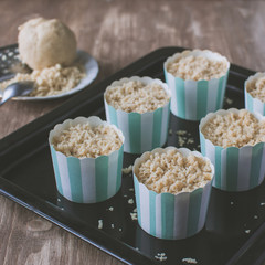 Making muffins, adding streusel to the pastry