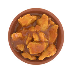 Top view of a small bowl filled with chicken chunks in barbecue sauce isolated on a white...