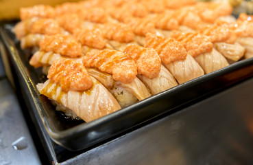 lot of beautiful  grilled salmon sushi.