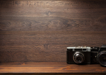 old camera at shelf wall wood