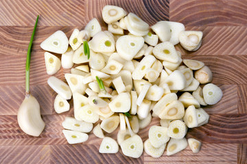 chopped garlic on wooden board.