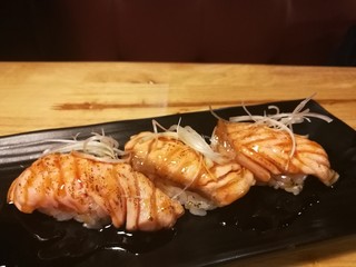 Salmon Sushi with a little burn on top, raw food, traditional Japanese food