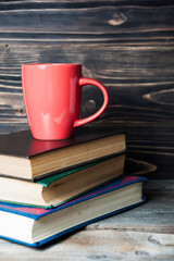 Fototapeta na wymiar Hot coffee or tea, cocoa, chocolate cup on books