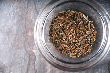 Glass bowl with cumin on the table