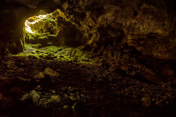 Entrance to dark karst cave in jungle, inside mountain subterranean for background. Concept of...