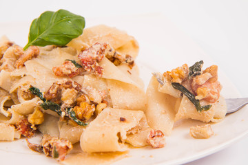 Pasta with cream sauce with bacon, mushrooms, walnuts, spinach