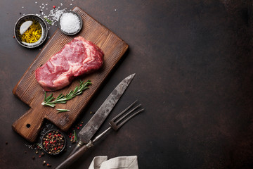 Raw ribeye beef steak cooking with ingredients