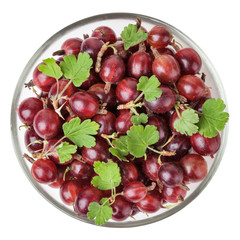 Red gooseberry with leaves in glass bowl isolated on white background with clipping path