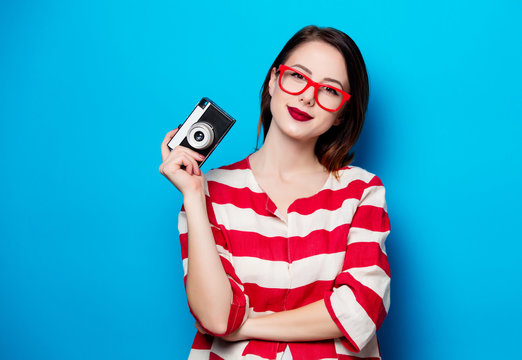 Young Smiling Woman With Retro Camera